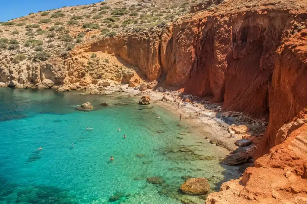 best beaches in Malta 2026 secluded bay with red sandstone cliffs