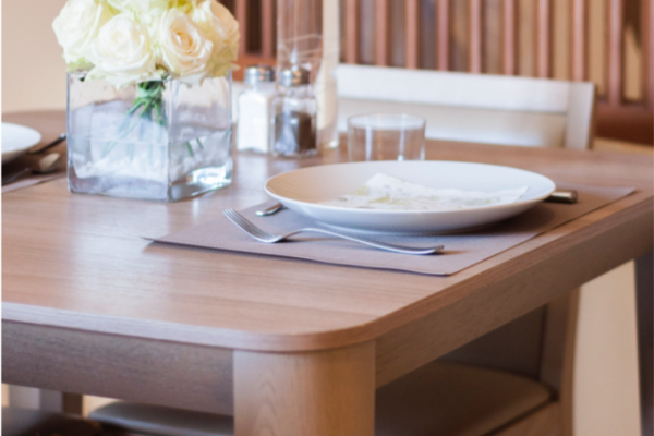St Blubay suite dining table with plates and flowers on it