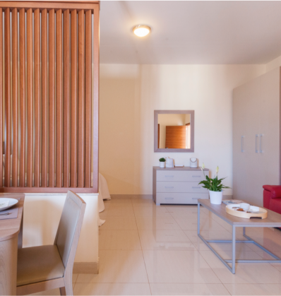 The dining table, a mirror in the living room, and a study table at the St Hotel Blubay suites