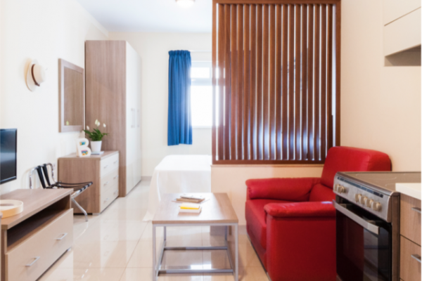 Self catering kitchen and sofa in the living room of St Hotel Blubay apartment