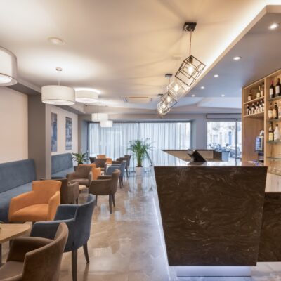 Lobby of St hotels Malta with chairs and tables and drinks