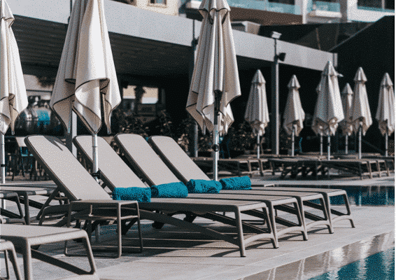 Sunbathing in Azur hotel Sunbathing chairs next to the pool with sunshade in Azur hotel